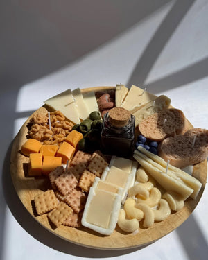 Decorative candle in the shape of a cheese board